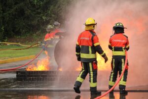 Firefighters extinguish flames during a training exercise.