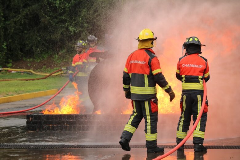 Firefighters extinguish flames during a training exercise.